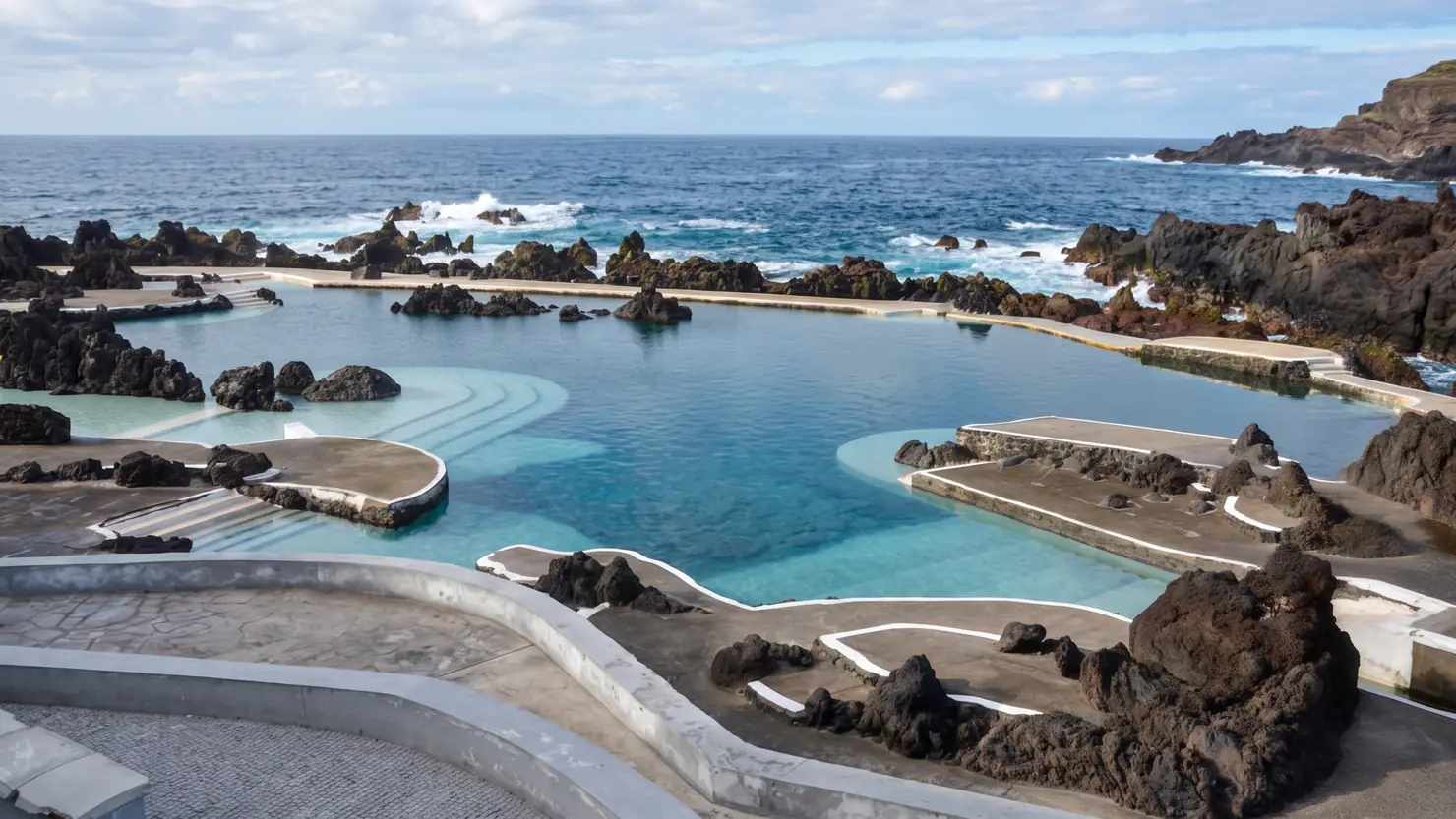 The lava pools at Porto Moniz, about 3,800 square metres of them. The main complex costs around €3 in 2026; the older pools by the São João Baptista fort are free.