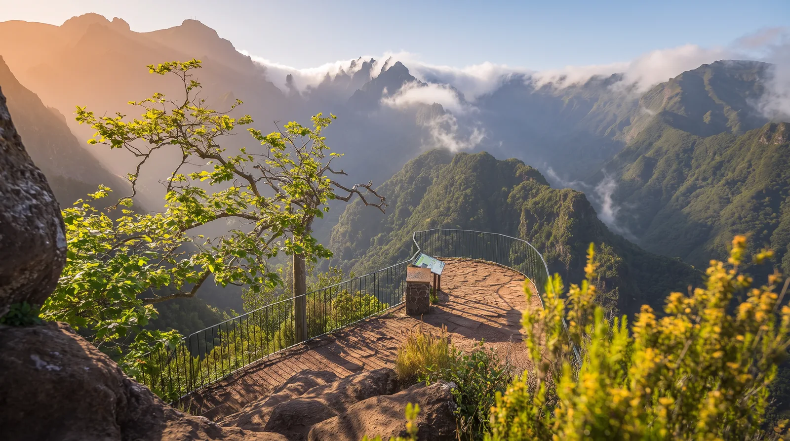The semicircular Balcões viewpoint terrace above a forested valley with peaks behind
