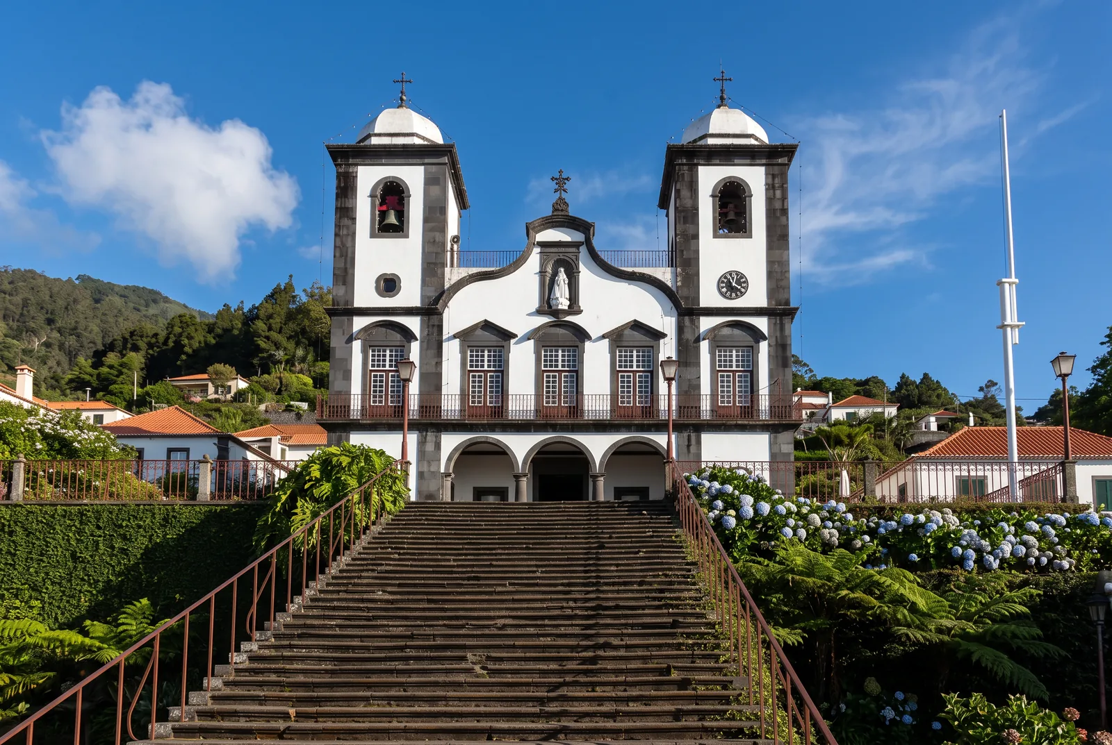 The white twin-towered church of Monte at the top of a long stone staircase