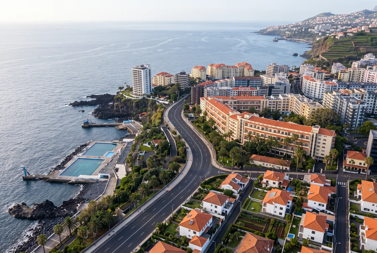 The Estrada Monumental curving along the coast between the hotel line and the sea