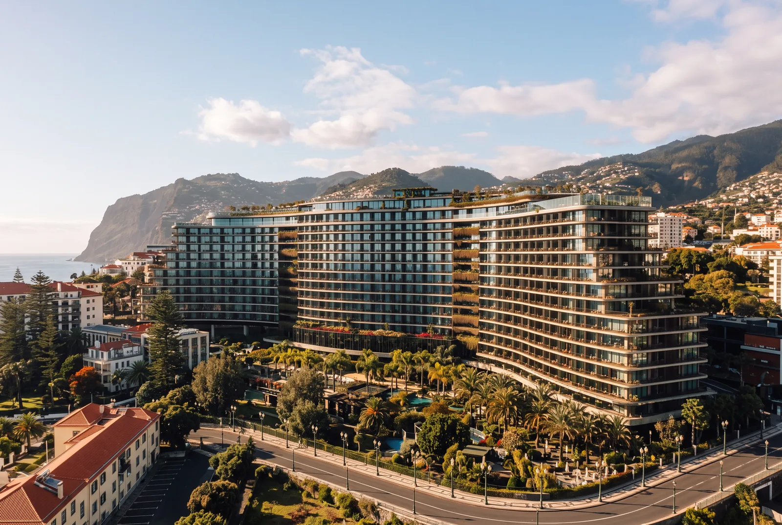 The wave shaped facade of the Savoy Palace hotel above Avenida do Infante in Funchal, in late afternoon light