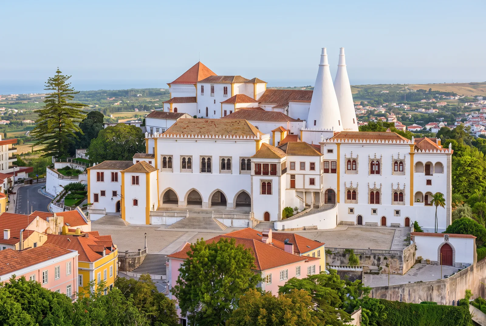 The National Palace of Sintra and its two conical chimneys above the old town, in early morning light