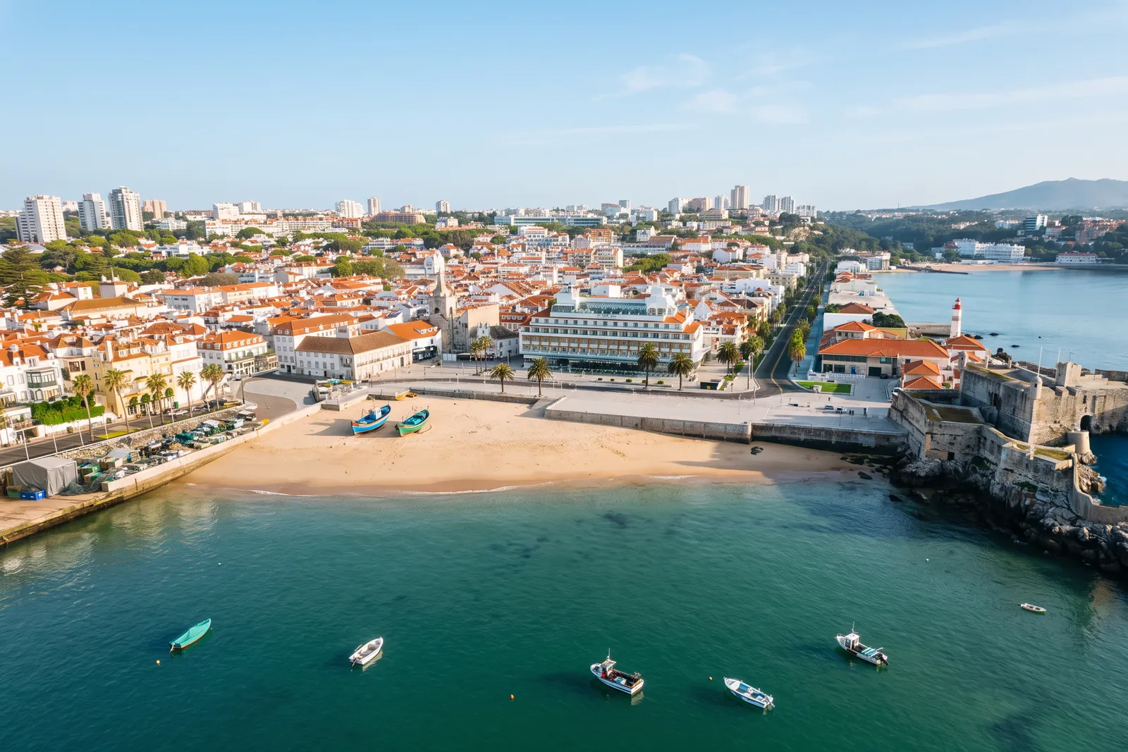 Aerial view of Cascais bay with fishing boats moored and the Cidadela on the promontory