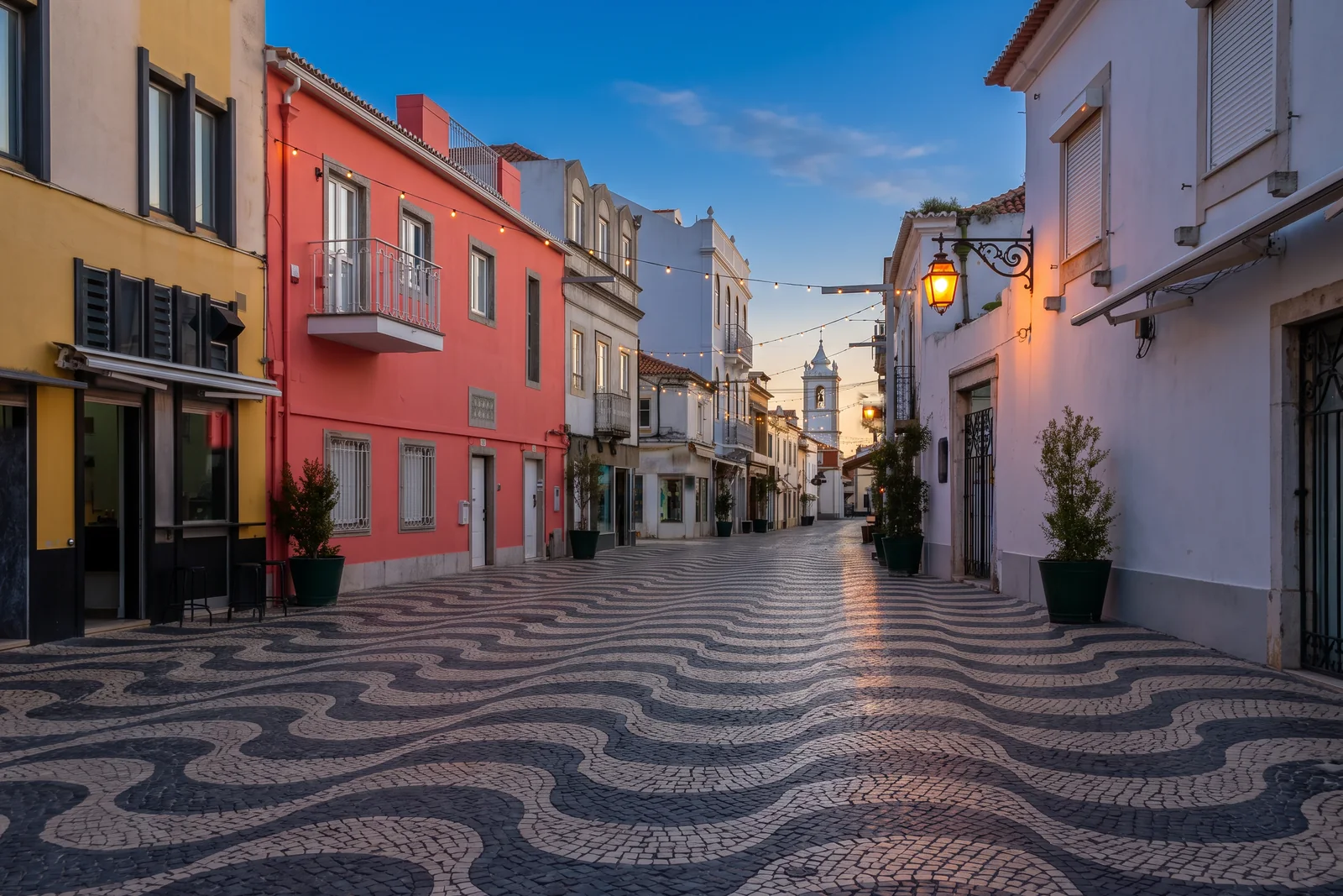 A street in the Cascais old town at blue hour with the lamps lit