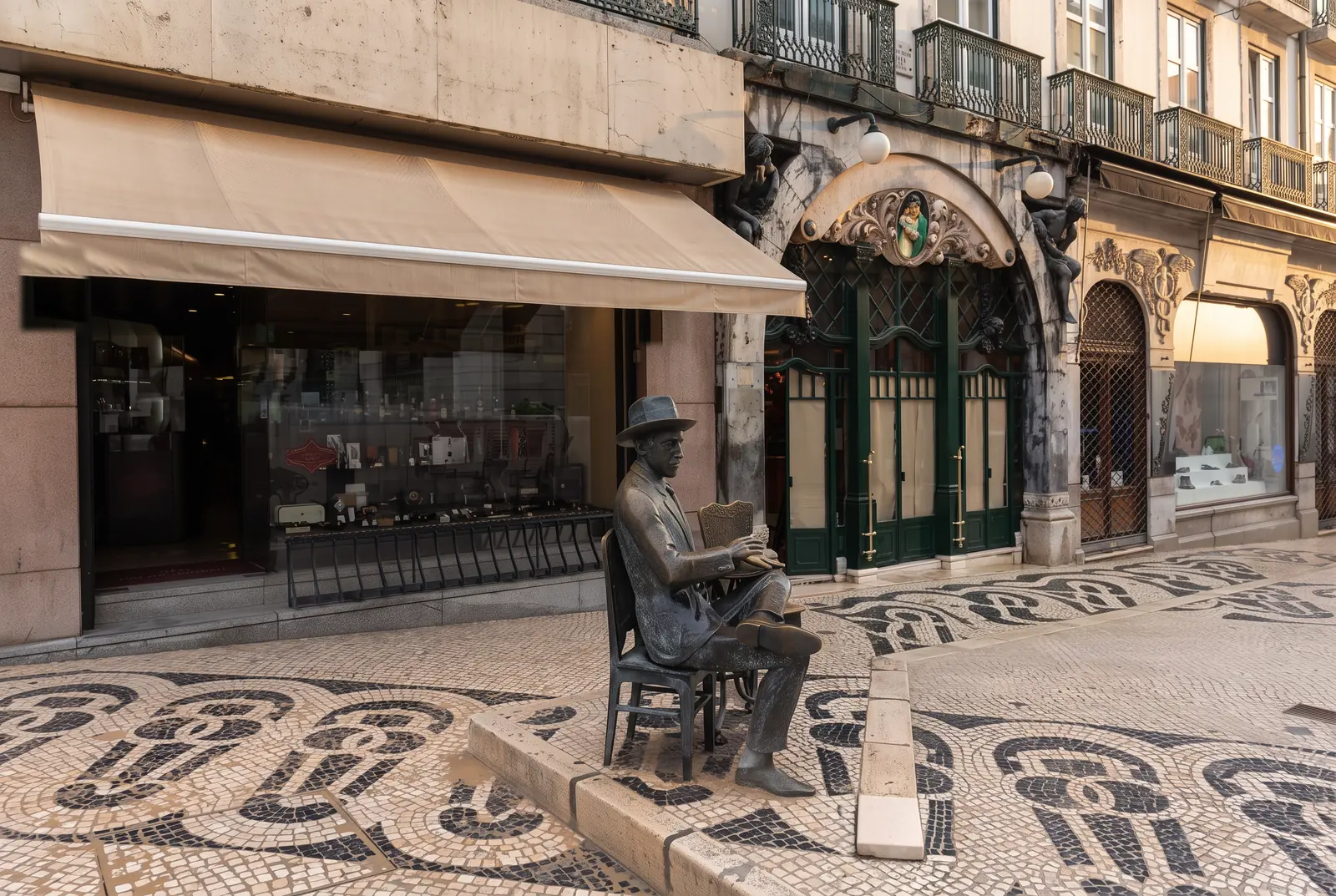 The bronze statue of Fernando Pessoa seated outside A Brasileira in Largo do Chiado at dawn