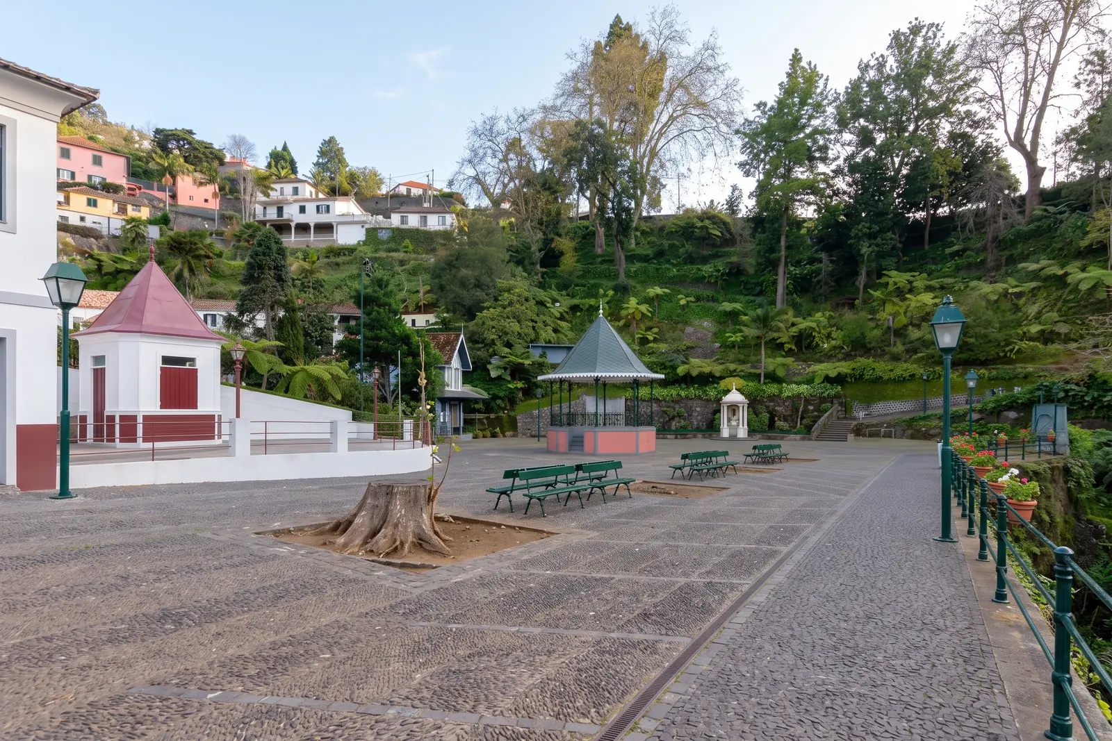 Largo da Fonte in Monte, with the cast-iron bandstand, the small white Fountain of the Virgin and the cobbled square